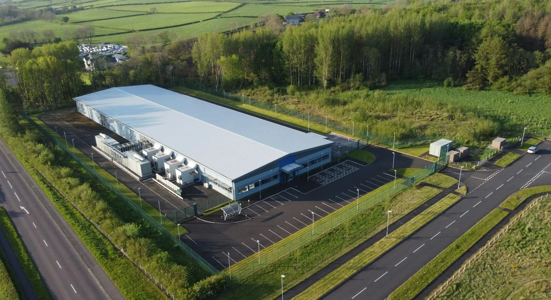 Aerial view of a data center building surrounded by countryside